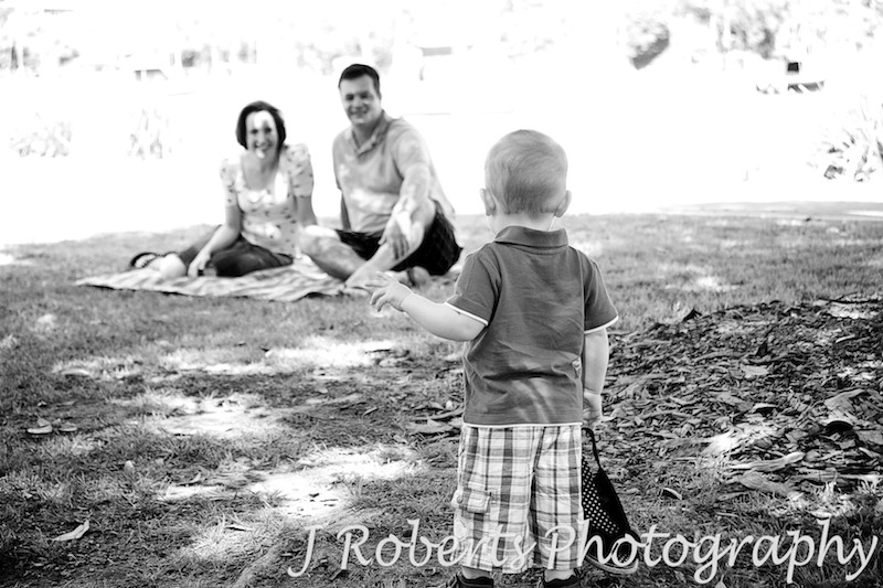 Little boy looking back at his parents - family portrait photography sydney